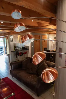 a living room with a brown couch and lights at Morgane Apartment in Chamonix-Mont-Blanc