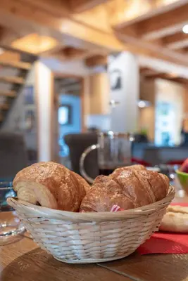 a basket of bread sitting on top of a table at Morgane Apartment in Chamonix-Mont-Blanc