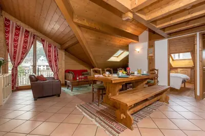 a living room with a wooden table and a couch at Polaris - Chamonix in Chamonix-Mont-Blanc
