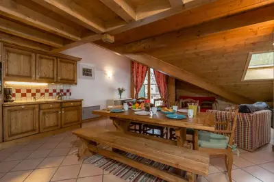 a large kitchen with a wooden table in a room at Polaris - Chamonix in Chamonix-Mont-Blanc