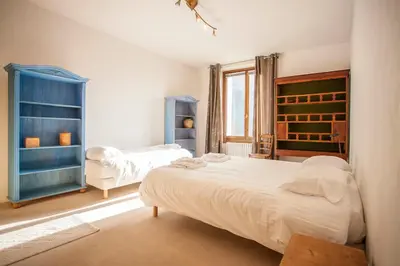a bedroom with two beds and a blue cabinet at Vieux Palais - Chamonix in Chamonix-Mont-Blanc