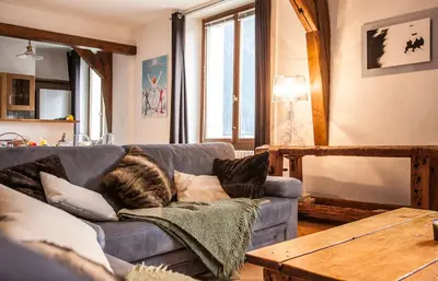 a living room with a couch and a table at Vieux Palais - Chamonix in Chamonix-Mont-Blanc