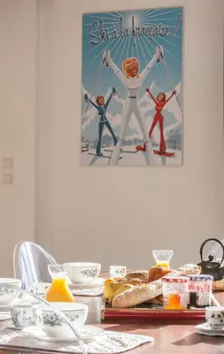 a table with a poster of a spider man on the wall at Vieux Palais - Chamonix in Chamonix-Mont-Blanc