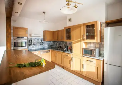 a kitchen with wooden cabinets and a wooden counter top at Vieux Palais - Chamonix in Chamonix-Mont-Blanc