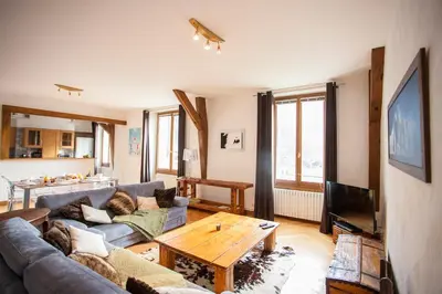 a living room with a couch and a table at Vieux Palais - Chamonix in Chamonix-Mont-Blanc