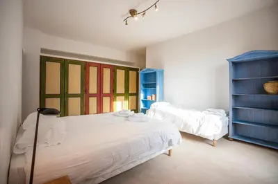 a bedroom with two beds and colorful windows at Vieux Palais - Chamonix in Chamonix-Mont-Blanc