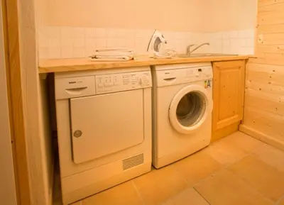 a kitchen with a washing machine and a sink at Chalet Bois - Chamonix in Chamonix-Mont-Blanc