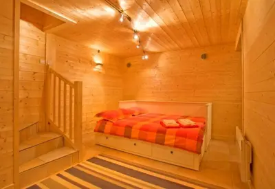 a bedroom with a bed in a wooden cabin at Chalet Bois - Chamonix in Chamonix-Mont-Blanc