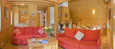 a living room with red couches and a fireplace at Chalet Bois - Chamonix in Chamonix-Mont-Blanc