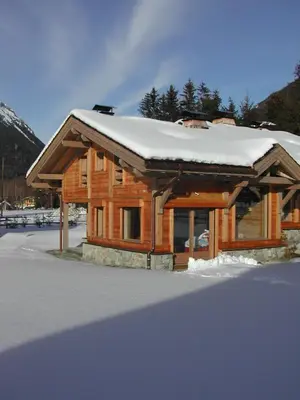a log cabin with snow on top of it at Chalet Bois - Chamonix in Chamonix-Mont-Blanc