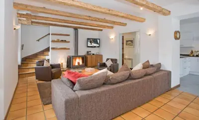 a living room with a couch and a fireplace at Chalet des Lacs - Chamonix in Chamonix-Mont-Blanc