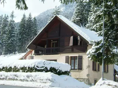 a house covered in snow in front at Chalet des Lacs - Chamonix in Chamonix-Mont-Blanc