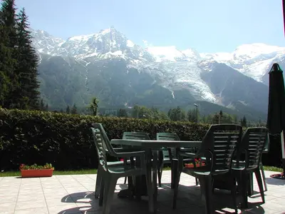a table and chairs with a view of a mountain at Chalet des Lacs - Chamonix in Chamonix-Mont-Blanc