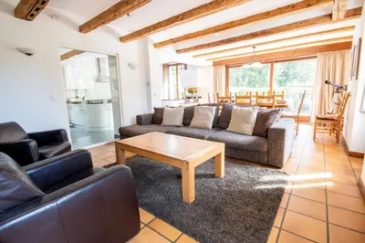 a living room with two couches and a table at Chalet des Lacs - Chamonix in Chamonix-Mont-Blanc
