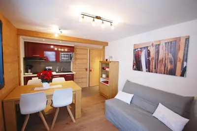 a living room with a couch and a table at Appartement 25m2 à Saint-Gervais les bains in Saint-Gervais-les-Bains