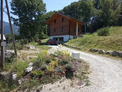 a house on a hill with a dirt road at Appartement 25m2 à Saint-Gervais les bains in Saint-Gervais-les-Bains