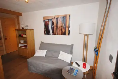 a living room with a couch and a table at Appartement 25m2 à Saint-Gervais les bains in Saint-Gervais-les-Bains