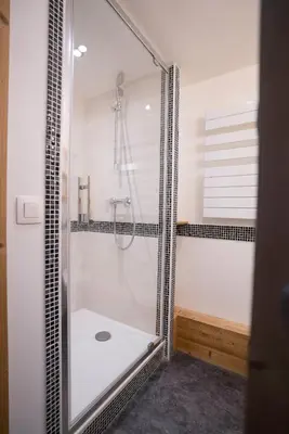 a bathroom with a shower with a glass door at Village De Vacances Les Flocons Verts in Les Carroz d'Araches