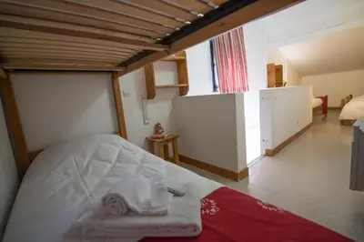 a bedroom with a bed with towels on it at Village De Vacances Les Flocons Verts in Les Carroz d'Araches