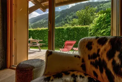 a living room with a couch and a view of a patio at Blaitiere 2 Apartment in Chamonix-Mont-Blanc