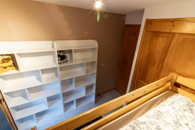 a room with a bed with white shelves at Samoëns Apartment 2 bedroom 50m2 modern and well equipt in Samoëns