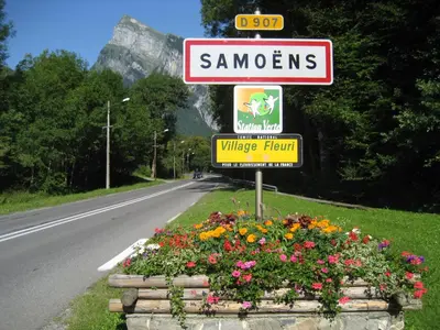 a sign on a road with flowers on the side at Samoëns Apartment 2 bedroom 50m2 modern and well equipt in Samoëns