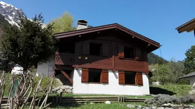 a small wooden house with windows and a roof at Chalet Erminea in Chamonix-Mont-Blanc