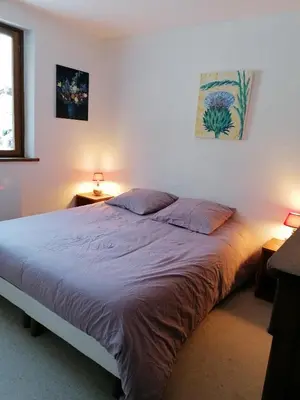 a bedroom with a large bed with two lamps at Chalet Erminea in Chamonix-Mont-Blanc