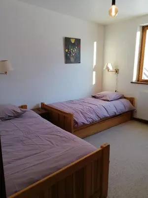a bedroom with two beds and a window at Chalet Erminea in Chamonix-Mont-Blanc