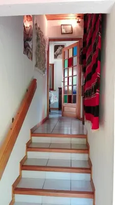 a hallway with stairs with a door in a house at Chalet Erminea in Chamonix-Mont-Blanc