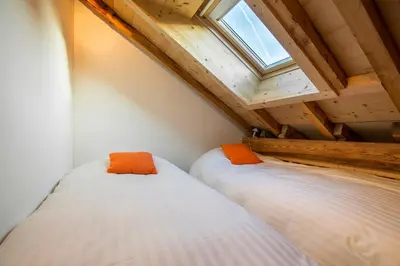 a hallway with a door leading into a room with a kitchen at Les Edelweiss Mont-Blanc - Gîte Classé 3 Etoiles in Passy