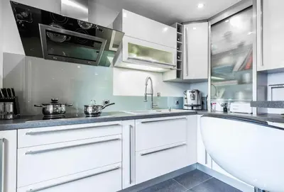 a kitchen with white cabinets and a sink at Les Edelweiss Mont-Blanc - Gîte Classé 3 Etoiles in Passy