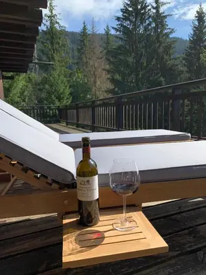 a bottle of wine and a glass on a table at Chalet Krystal in Arâches-la-Frasse