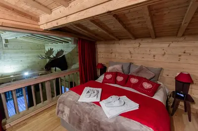 a bedroom with a bed with two towels on it at Chalet Krystal in Arâches-la-Frasse