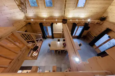 an overhead view of a wooden cabin with a table and stairs at Chalet Krystal in Arâches-la-Frasse