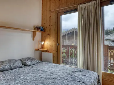 a bedroom with a bed and a large window at Chalet 4 Chambres à Megève, 10 Pers, Calme, Wifi, Proche Centre - FR-1-453-1 in Megève