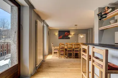 a kitchen and dining room with a table and chairs at APARTMENT PRESIDENT - Alpes Travel - Central Chamonix - Sleeps 12 in Chamonix-Mont-Blanc