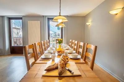 a cat sitting on a table in a dining room at APARTMENT PRESIDENT - Alpes Travel - Central Chamonix - Sleeps 12 in Chamonix-Mont-Blanc