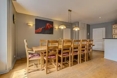 a kitchen and dining room with a table and chairs at APARTMENT PRESIDENT - Alpes Travel - Central Chamonix - Sleeps 12 in Chamonix-Mont-Blanc
