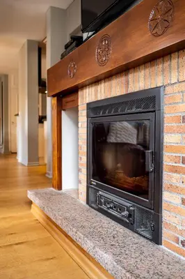 a brick fireplace with a television on top of it at APARTMENT PRESIDENT - Alpes Travel - Central Chamonix - Sleeps 12 in Chamonix-Mont-Blanc