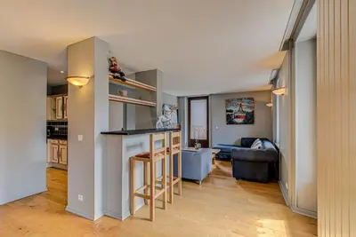 a living room with a couch and a table at APARTMENT PRESIDENT - Alpes Travel - Central Chamonix - Sleeps 12 in Chamonix-Mont-Blanc