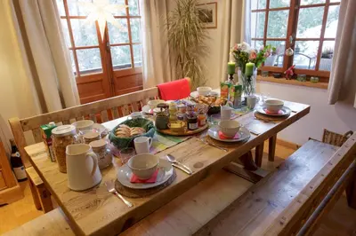 a wooden table with food on top of it at The Guest House in Vallorcine