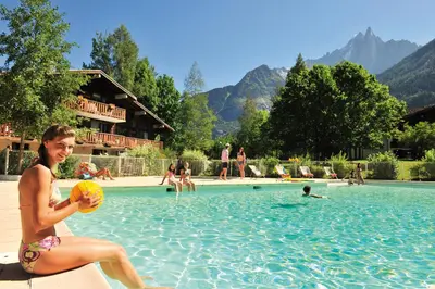 a woman holding a volleyball in a swimming pool at VTF Les Econtres in Chamonix-Mont-Blanc