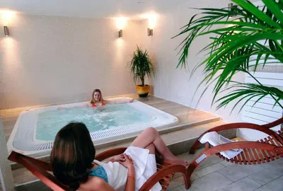 two women sitting in chairs in a hot tub at VTF Les Econtres in Chamonix-Mont-Blanc
