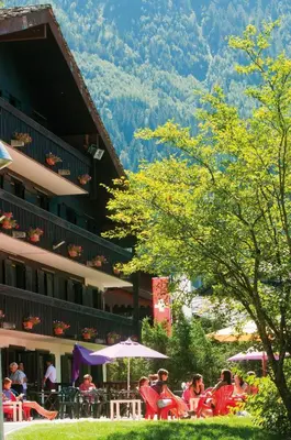 a group of people sitting outside of a hotel at VTF Les Econtres in Chamonix-Mont-Blanc
