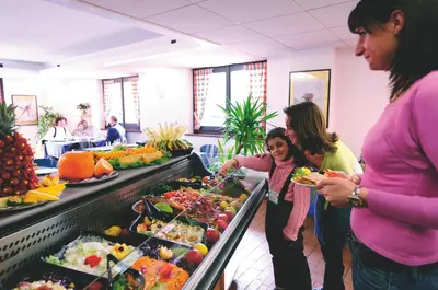 a group of people standing around a buffet of food at VTF Les Econtres in Chamonix-Mont-Blanc