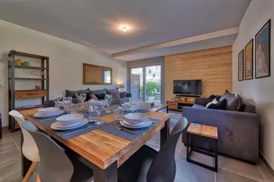 a dining room with a table and a couch at Base Camp: Residence Ferme de Montenvers in Chamonix-Mont-Blanc