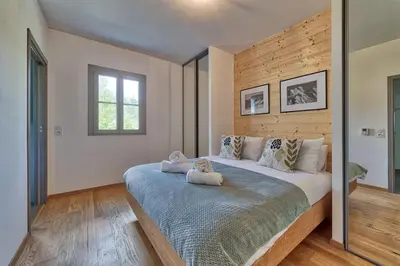 a bedroom with a large bed with two teddy bears on it at Base Camp: Residence Ferme de Montenvers in Chamonix-Mont-Blanc