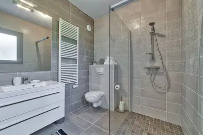 a bathroom with a shower and a toilet and a sink at Base Camp: Residence Ferme de Montenvers in Chamonix-Mont-Blanc