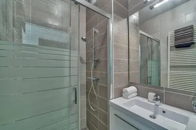 a bathroom with a shower and a sink and a mirror at Base Camp: Residence Ferme de Montenvers in Chamonix-Mont-Blanc